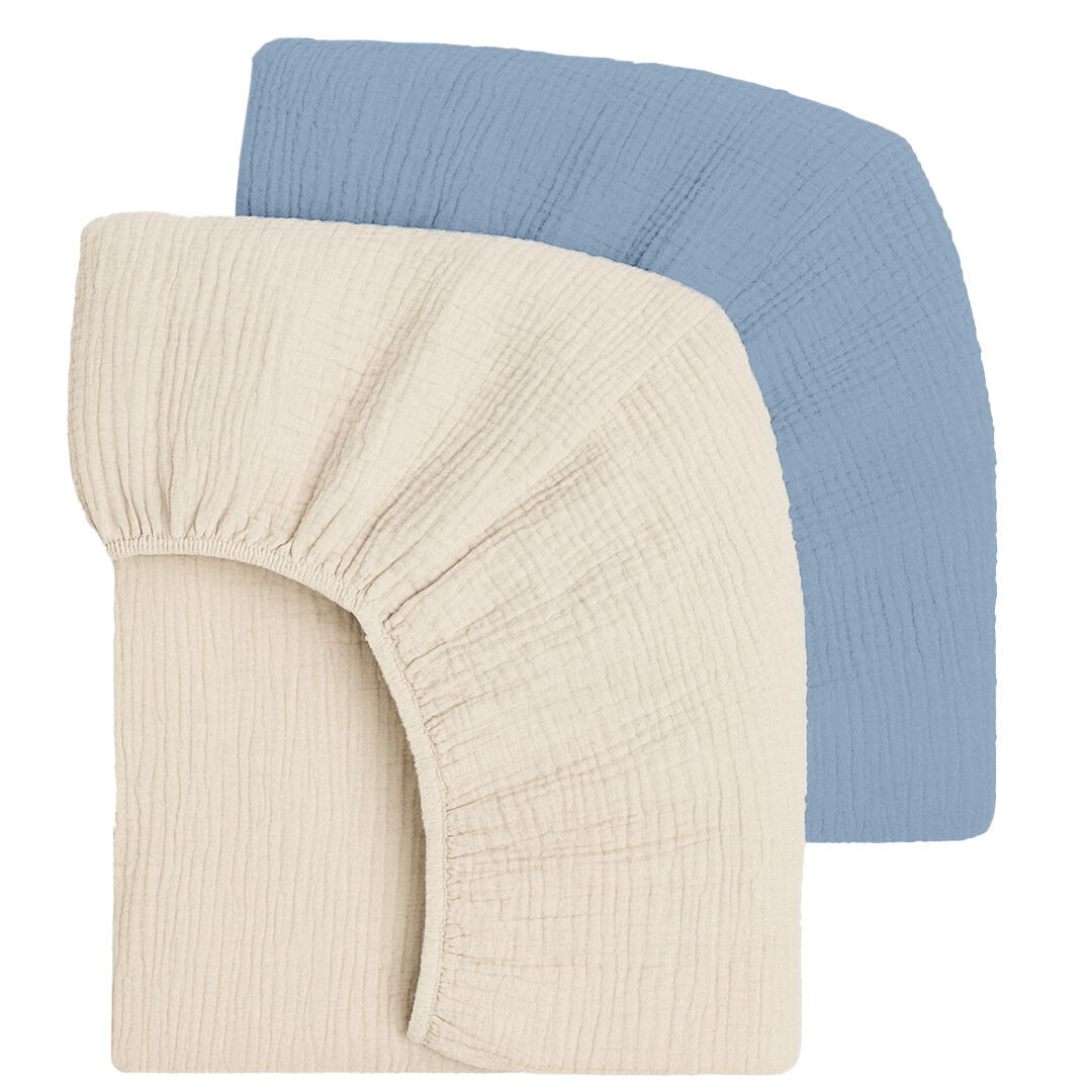 Two fitted crib sheets, one cream and one light blue, on a white background.