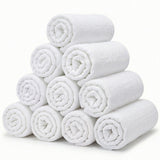 White muslin baby washcloths rolled into a stack, soft cotton wash cloths for baby bath time and daily cleaning