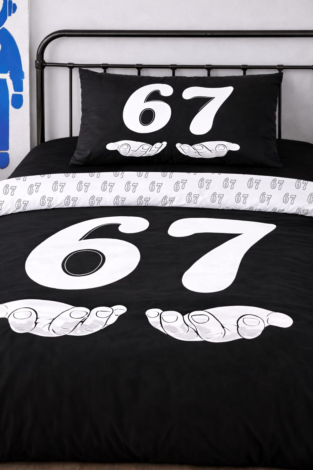 Close-up of 6-7 black twin duvet cover and matching pillow with white number 67 cartoon design, reversible bedding set