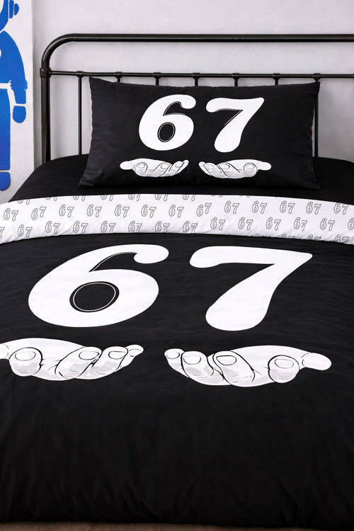 Close-up of 6-7 black twin duvet cover and matching pillow with white number 67 cartoon design, reversible bedding set