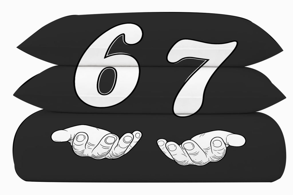 Detail of 6-7 bedding graphic — bold white number 67 with cartoon hands on black duvet cover, reversible side shown